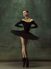 Image showing Young graceful tender ballerina on dark studio background