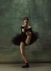 Image showing Young graceful tender ballerina on dark studio background