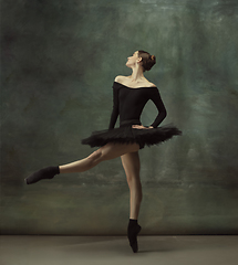 Image showing Young graceful tender ballerina on dark studio background