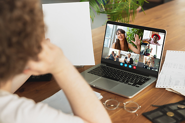 Image showing Man participate video conference looking at laptop screen during virtual meeting, videocall webcam app for business, close up