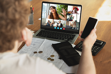 Image showing Man participate video conference looking at laptop screen during virtual meeting, videocall webcam app for business, close up