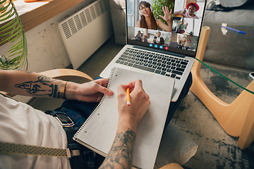 Image showing Man participate video conference looking at laptop screen during virtual meeting, videocall webcam app for business, close up