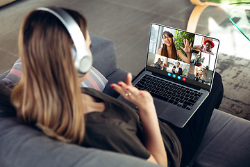 Image showing Woman participate video conference looking at laptop screen during virtual meeting, videocall webcam app for business, close up