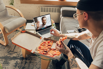 Image showing Man participate video conference looking at laptop screen during virtual meeting, videocall webcam app for business, close up