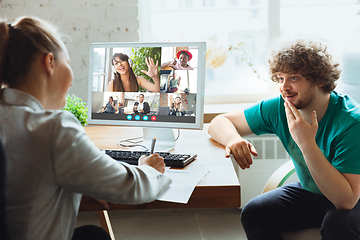 Image showing Young man and woman participate video conference looking at laptop screen during virtual meeting, videocall webcam app for business, close up