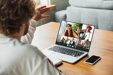 Image showing Man participate video conference looking at laptop screen during virtual meeting, videocall webcam app for business, close up