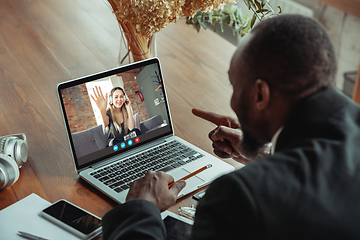 Image showing Man participate video conference looking at laptop screen during virtual meeting, videocall webcam app for business, close up