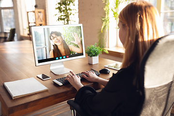 Image showing Woman participate video conference looking at laptop screen during virtual meeting, videocall webcam app for business, close up