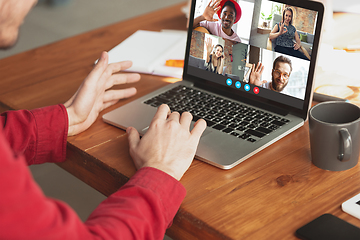 Image showing Man participate video conference looking at laptop screen during virtual meeting, videocall webcam app for business, close up