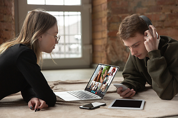 Image showing Young man and woman participate video conference looking at laptop screen during virtual meeting, videocall webcam app for business, close up