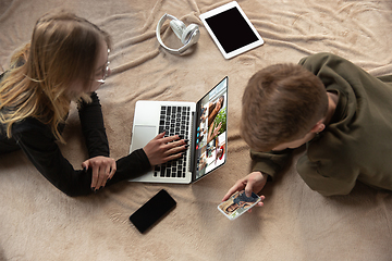 Image showing Young man and woman participate video conference looking at laptop screen during virtual meeting, videocall webcam app for business, close up