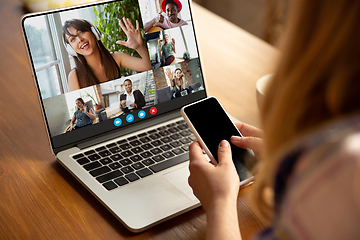 Image showing Woman participate video conference looking at laptop screen during virtual meeting, videocall webcam app for business, close up