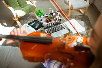 Image showing Woman participate video conference looking at laptop screen during virtual meeting, videocall webcam app for business, close up