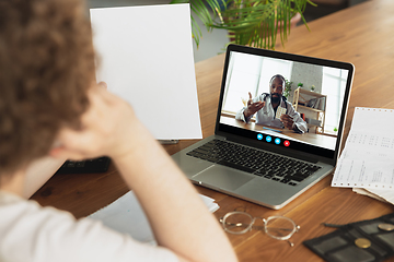 Image showing Man participate video conference looking at laptop screen during virtual meeting, videocall webcam app for business, close up