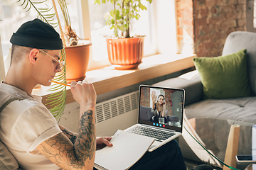 Image showing Man participate video conference looking at laptop screen during virtual meeting, videocall webcam app for business, close up