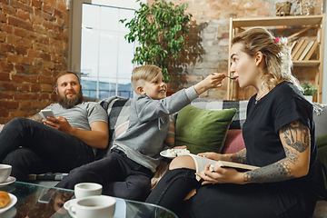 Image showing Happy family at home spending time together. Having fun, look cheerful and lovely.