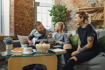 Image showing Happy family at home spending time together. Having fun, look cheerful and lovely.