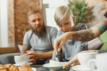 Image showing Happy family at home spending time together. Having fun, look cheerful and lovely.