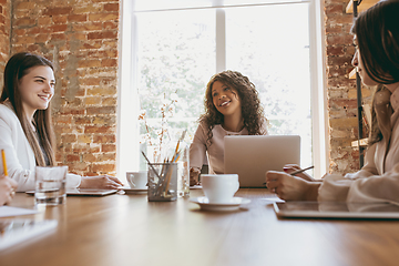 Image showing Business young caucasian woman in modern office with team