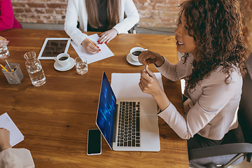 Image showing Business young caucasian woman in modern office with team