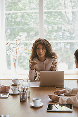 Image showing Business young caucasian woman in modern office with team