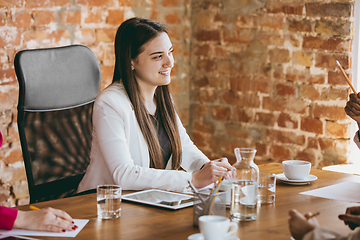 Image showing Business young caucasian woman in modern office with team