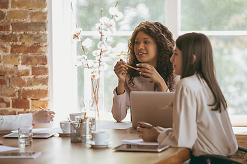 Image showing Business young caucasian woman in modern office with team