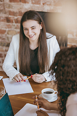 Image showing Business young caucasian woman in modern office with team