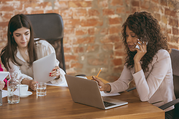 Image showing Business young caucasian woman in modern office with team