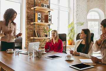 Image showing Business young caucasian woman in modern office with team