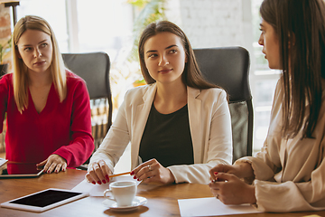 Image showing Business young caucasian woman in modern office with team