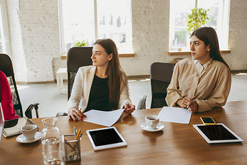 Image showing Business young caucasian woman in modern office with team