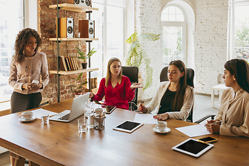 Image showing Business young caucasian woman in modern office with team