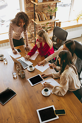 Image showing Business young caucasian woman in modern office with team