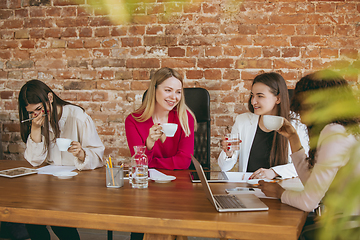 Image showing Business young caucasian woman in modern office with team