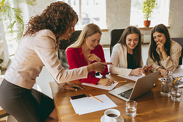 Image showing Business young caucasian woman in modern office with team