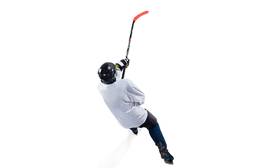 Image showing Unrecognizable male hockey player with the stick on ice court and white background