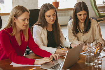 Image showing Business young caucasian woman in modern office with team