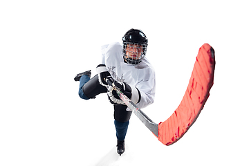 Image showing Unrecognizable male hockey player with the stick on ice court and white background