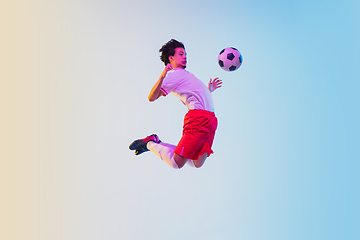 Image showing Football or soccer player on gradient background in neon light - motion, action, activity concept