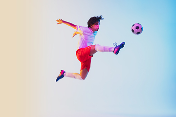 Image showing Football or soccer player on gradient background in neon light - motion, action, activity concept
