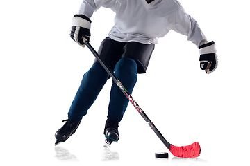 Image showing Unrecognizable male hockey player with the stick on ice court and white background
