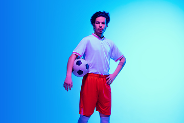 Image showing Football or soccer player on gradient background in neon light - motion, action, activity concept