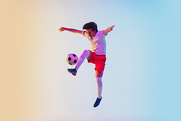 Image showing Football or soccer player on gradient background in neon light - motion, action, activity concept