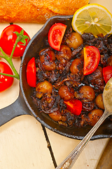 Image showing Baby cuttle fish roasted on iron skillet