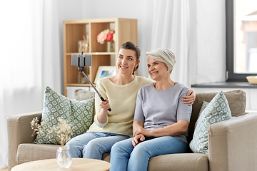 Image showing senior mother with daughter taking selfie at home