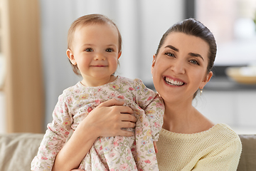 Image showing happy mother with little baby daughter at home