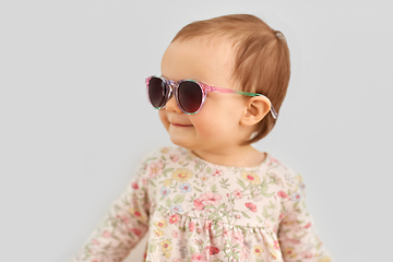 Image showing happy little baby girl in sunglasses over grey