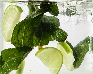 Image showing Close up view of the cold and fresh lemonade with light and mint, ice cubes