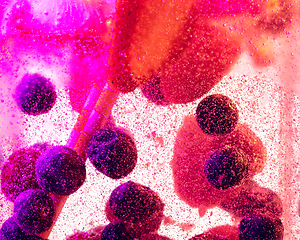 Image showing Close up view of the cold and fresh lemonade with bright berries in neon light